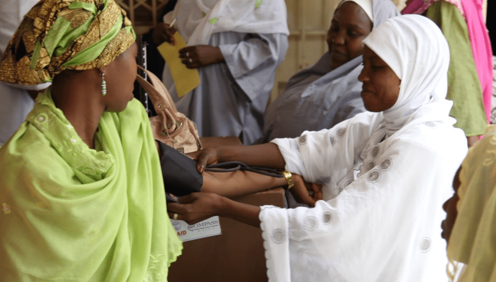 A health worker takes the blood pressure of a woman at a family planning and maternity clinic in Kano, Nigeria. Photo by Bonnie Gillespie, courtesy of Photoshare.