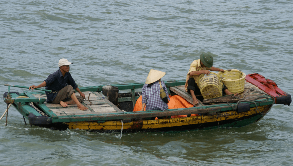 People ride in a boat in Vietnam. Photo by Patrik M. Loeff, courtesy of Flickr Creative Commons.