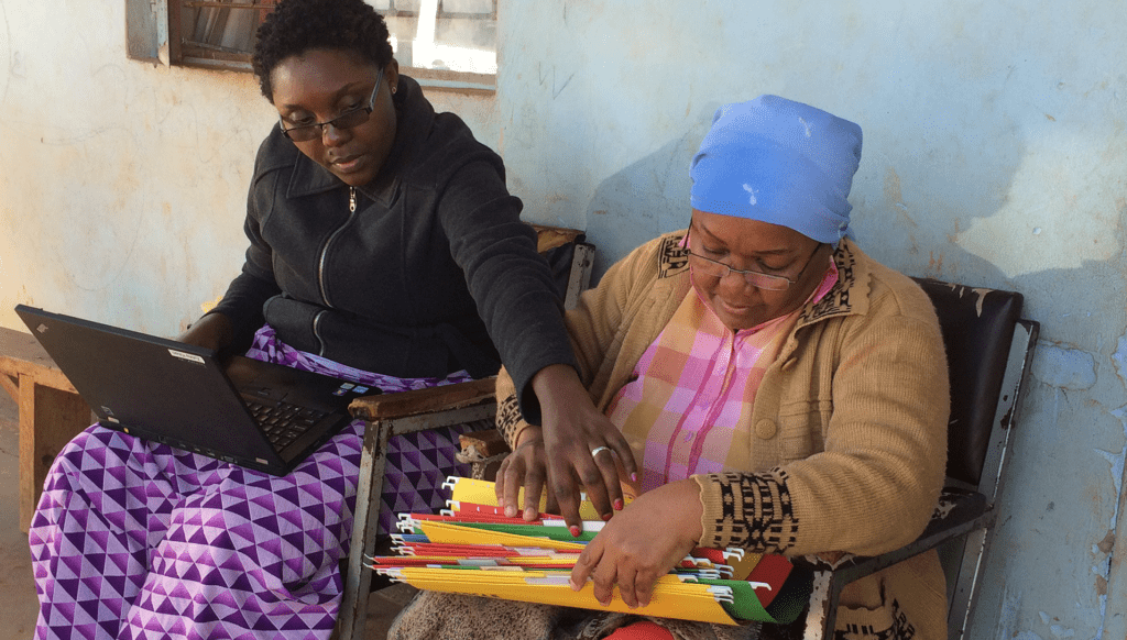 Women go through files in Zambia. Photo by Abby Cannon, MEASURE Evaluation.