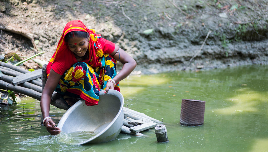 Woman at a pond in Bangladesh. Photo by WorldFish, courtesy of Flickr Creative Commons.